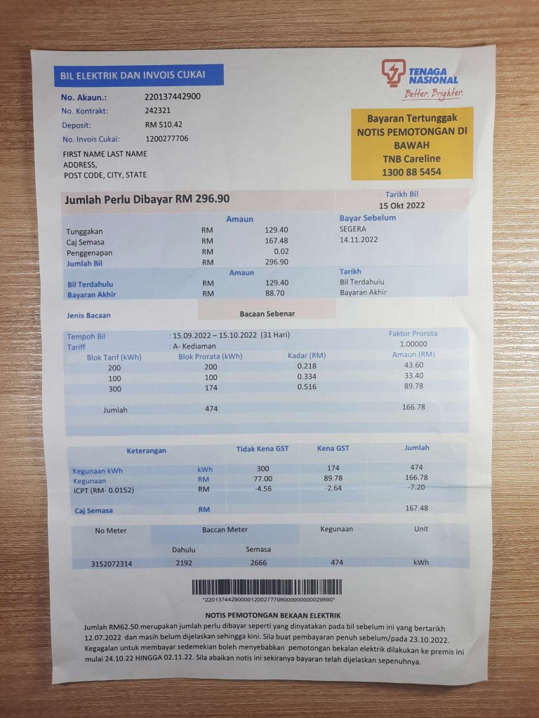 Malaysia Tenaga Nasional electricity utility bill shown on wood surface